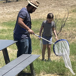 student demonstrating insect net