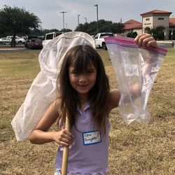 camper holding up bag with insects