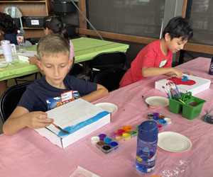 two campers decorating insect boxes