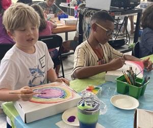 two campers decorating insect boxes