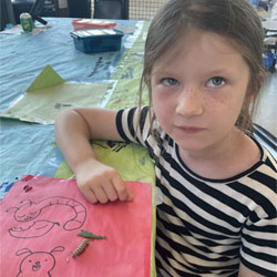 camper observing monarch butterfly caterpillar