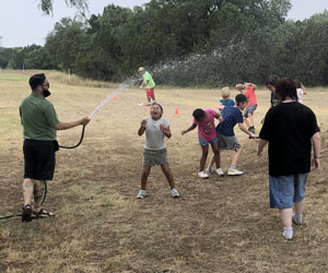 campers being sprayed with water