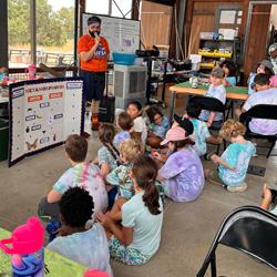 campers on floor around a metamorphosis whiteboard