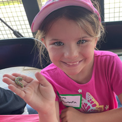 camper holding caterpillar