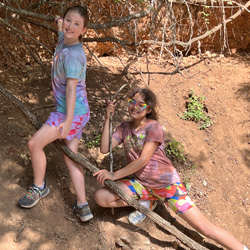 two camper on tree roots