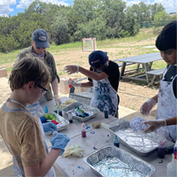 campers making tie-dye shirts