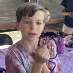 camper holding bead animal