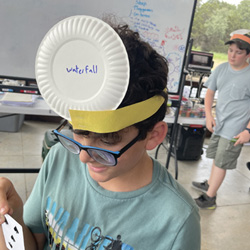 camper with Waterfall paper plate on head