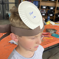 camper with Oxbow Lake paper plate on head