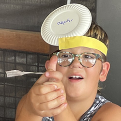 camper with Aquifer paper plate on head