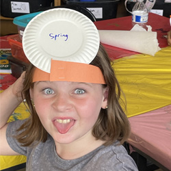 camper with Spring paper plate on head