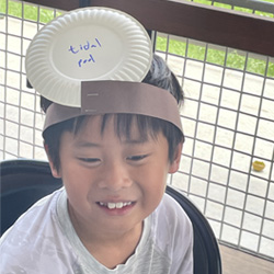 camper with Tidal Pool paper plate on head