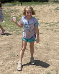 camper holding water balloon