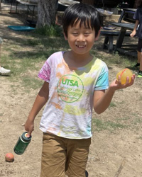 camper holding water balloons