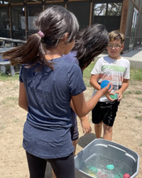 campers playing with water balloons