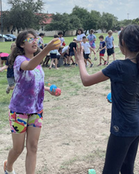 campers playing with water balloons