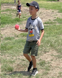 camper holding water balloon