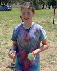 campers holding water balloon