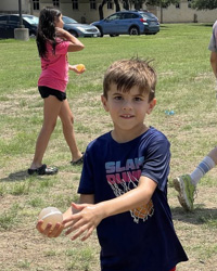 campers holding water balloon