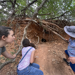 campers looking at cave entrance