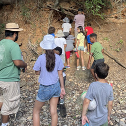 campers looking at cave entrance