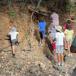 campers looking at cave entrance