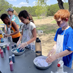 campers making tie-dye shirts