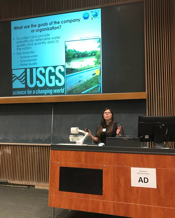 student participant gives her presentation to the audience