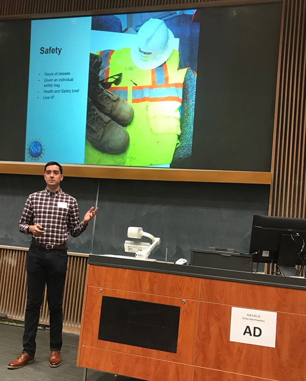 student participant gives his presentation to the audience