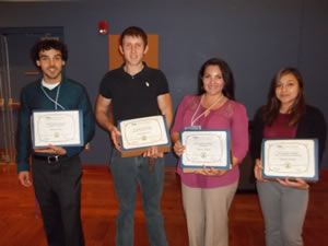 four students holding award certificates