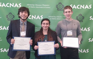 three students holding certificates