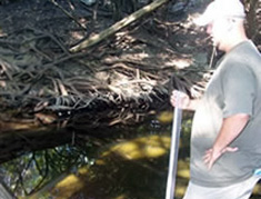 student standing by creek