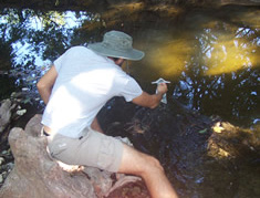 student taking water sample