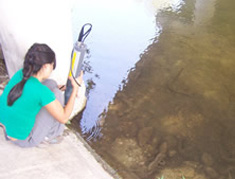 student examining creek