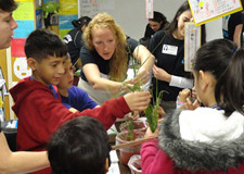 students planting in pots