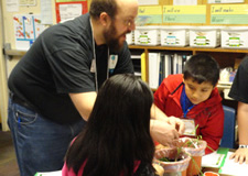 students planting in pots