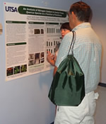 participants looking at research poster