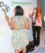 participants looking at research poster