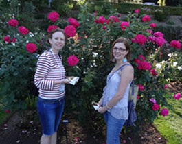 students and flower bush